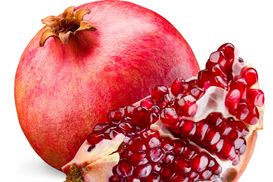 Pomegranate and its piece isolated on a white background. Produce